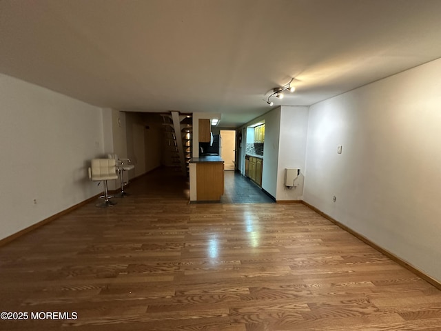 unfurnished living room featuring wood-type flooring