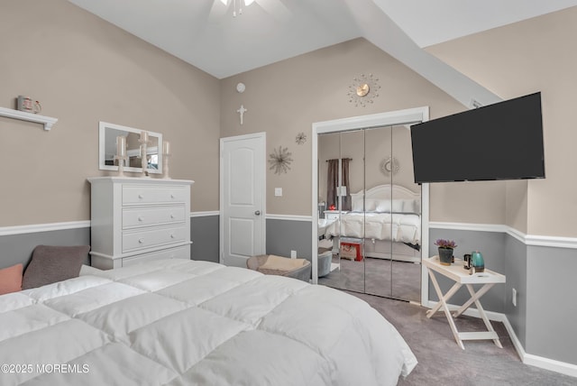 carpeted bedroom featuring ceiling fan, a closet, and lofted ceiling