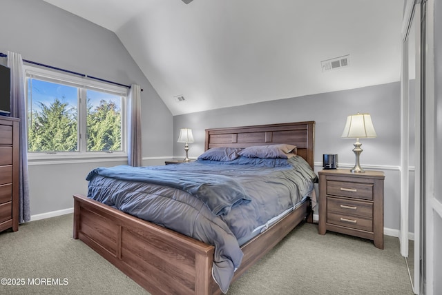 bedroom featuring light colored carpet and vaulted ceiling