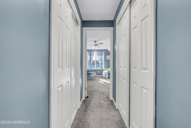 hallway with light colored carpet