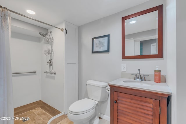 bathroom with tile patterned flooring, vanity, and toilet