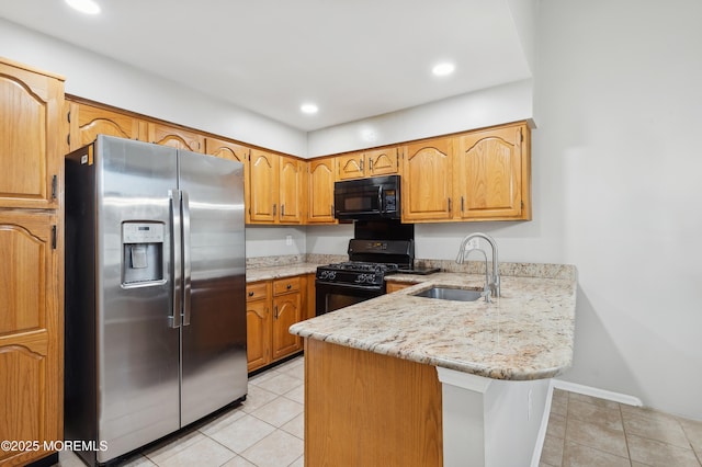 kitchen with black appliances, sink, kitchen peninsula, light stone counters, and light tile patterned floors