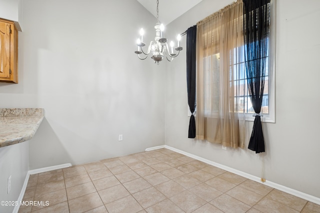 unfurnished dining area featuring vaulted ceiling, an inviting chandelier, and light tile patterned floors