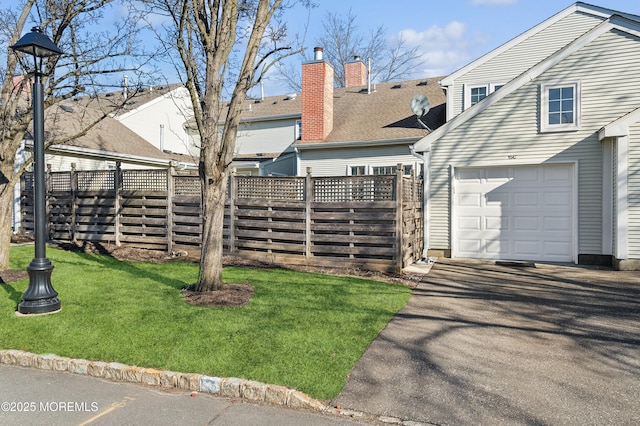 exterior space featuring a lawn and a garage