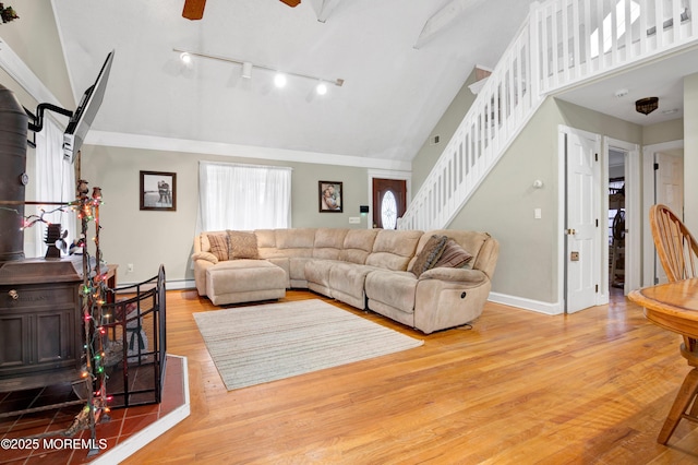 living room with ceiling fan, hardwood / wood-style floors, and high vaulted ceiling