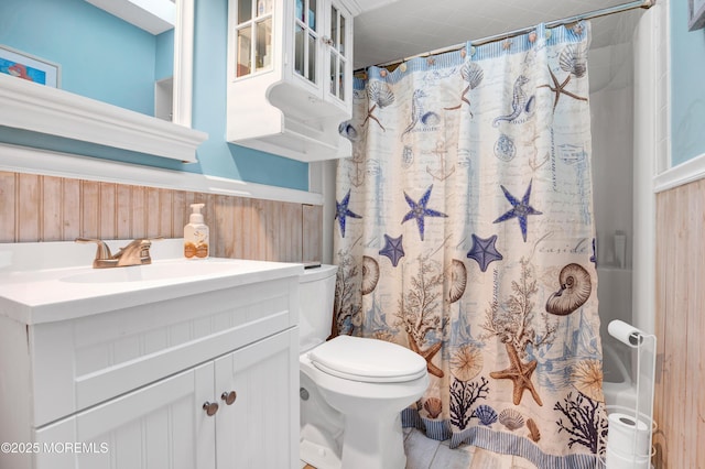 bathroom with vanity, a shower with curtain, and wooden walls