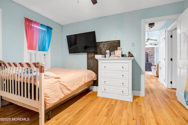 bedroom with ceiling fan and light hardwood / wood-style floors