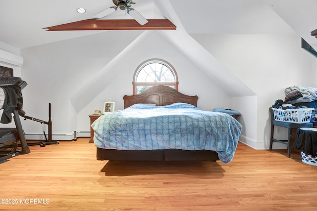 bedroom with baseboard heating, a wall unit AC, lofted ceiling with beams, light wood-type flooring, and ceiling fan