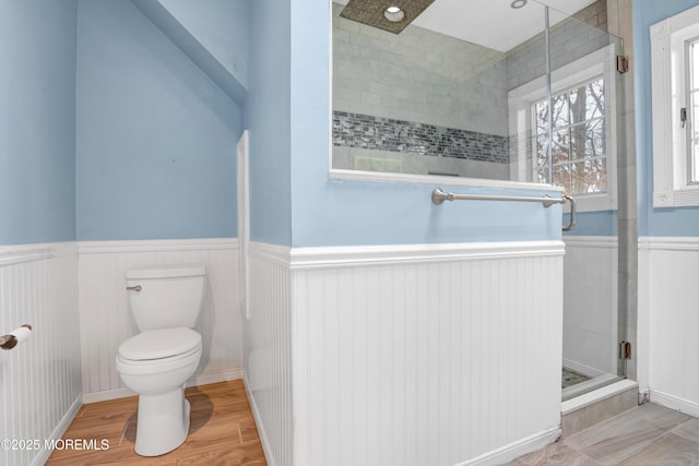 bathroom featuring walk in shower, toilet, and hardwood / wood-style floors