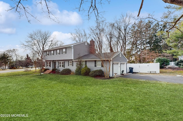 view of front of home with a garage and a front lawn