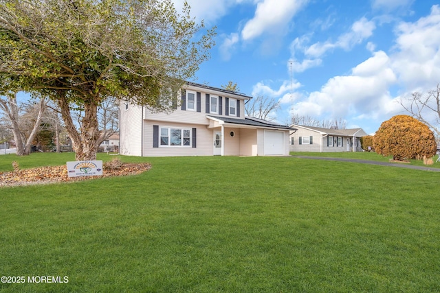 view of front of house with a garage and a front lawn