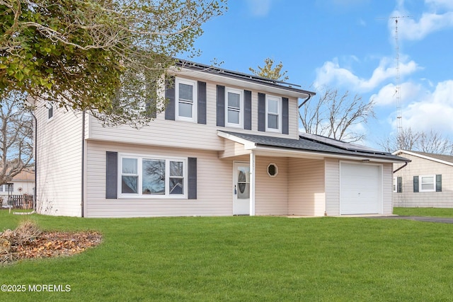 view of front of property featuring a garage and a front yard