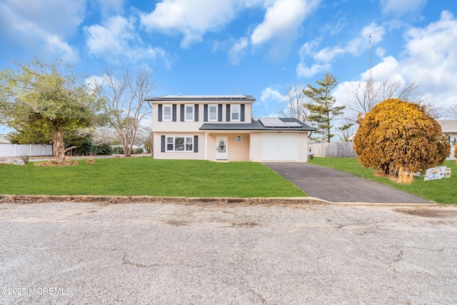 view of front property with a front yard and solar panels