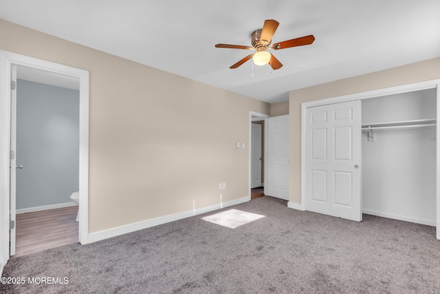 unfurnished bedroom featuring ensuite bath, carpet flooring, ceiling fan, and a closet