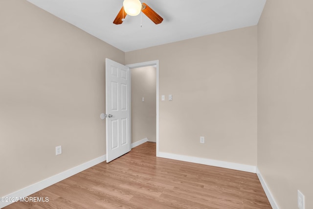 empty room with ceiling fan and light hardwood / wood-style floors