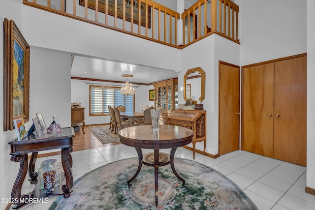 entrance foyer with a high ceiling, light tile patterned floors, and a notable chandelier