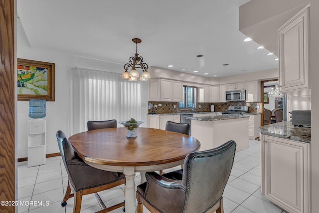 dining room with a notable chandelier and light tile patterned flooring