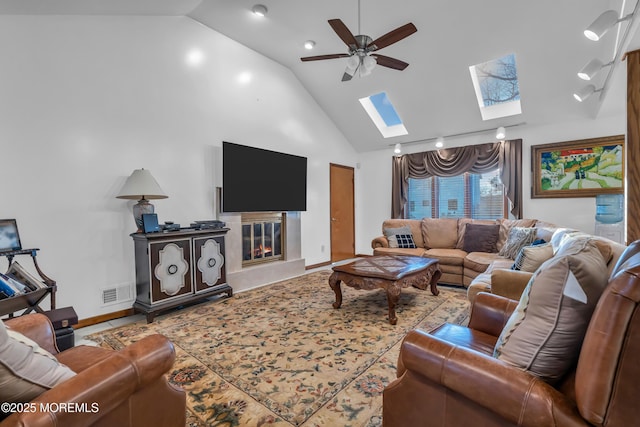 living room with ceiling fan, high vaulted ceiling, and a high end fireplace