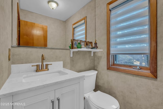 bathroom featuring toilet and vanity