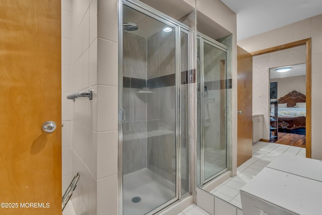 bathroom featuring walk in shower and tile patterned flooring