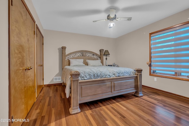 bedroom featuring ceiling fan, a closet, and hardwood / wood-style floors