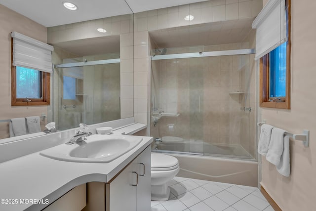 full bathroom with toilet, enclosed tub / shower combo, tile patterned floors, and vanity