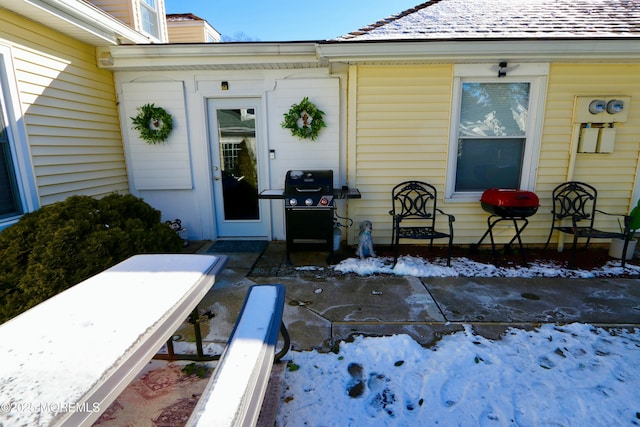 view of snow covered property entrance