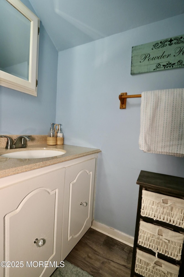 bathroom with vanity and hardwood / wood-style flooring