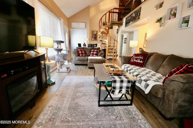 living room featuring vaulted ceiling and light wood-type flooring