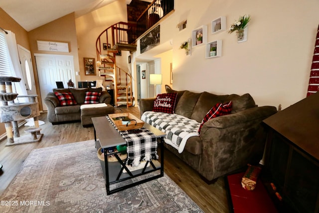 living room with high vaulted ceiling and hardwood / wood-style flooring