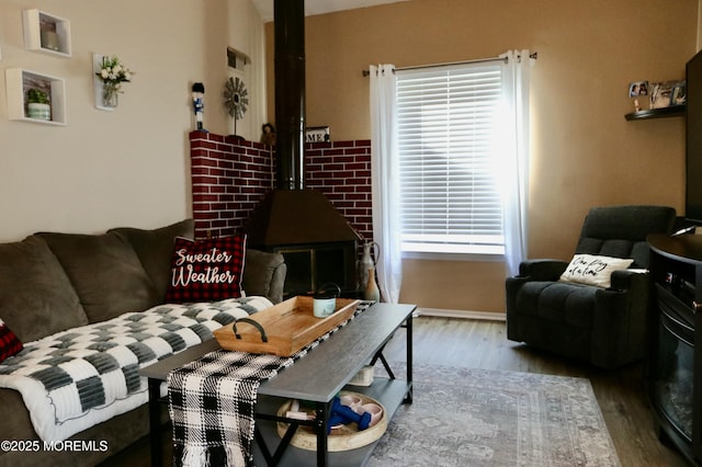 living room with light hardwood / wood-style floors and a wood stove