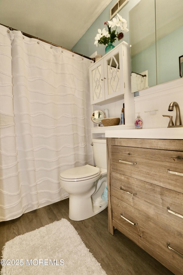 bathroom featuring hardwood / wood-style floors, vanity, and toilet