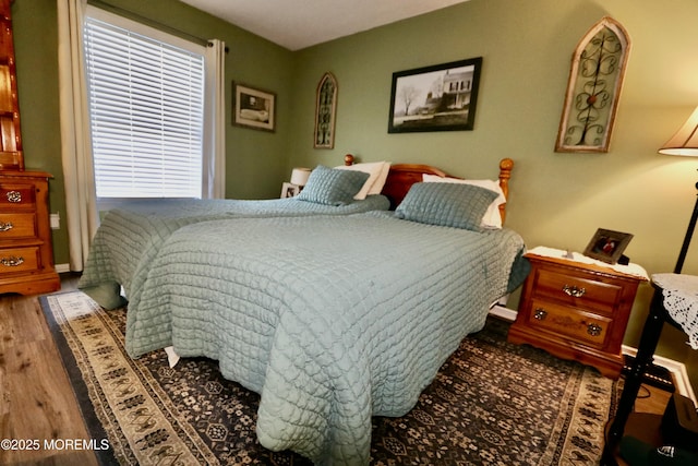 bedroom featuring hardwood / wood-style floors and multiple windows