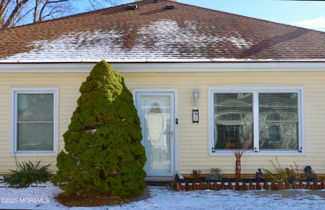 view of snow covered property entrance