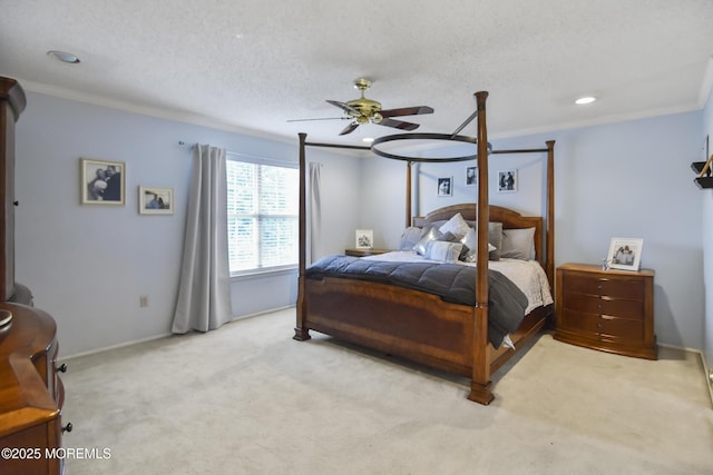 carpeted bedroom with ceiling fan, a textured ceiling, and ornamental molding