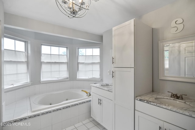 bathroom featuring tile patterned flooring, vanity, a relaxing tiled tub, and an inviting chandelier