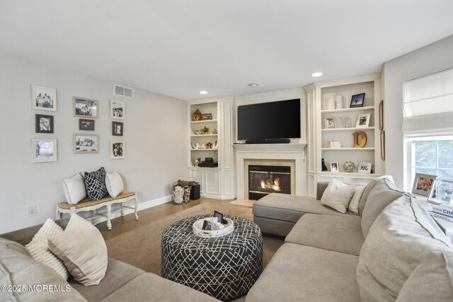 living room with hardwood / wood-style flooring and built in features