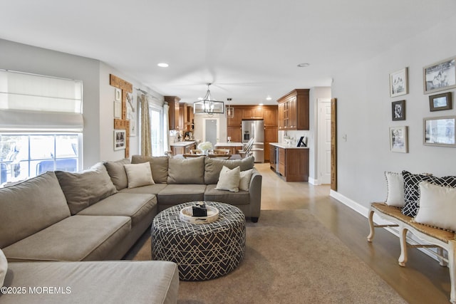 living room featuring light hardwood / wood-style flooring and an inviting chandelier