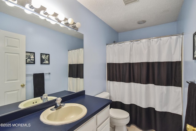 bathroom with a shower with shower curtain, vanity, toilet, and a textured ceiling