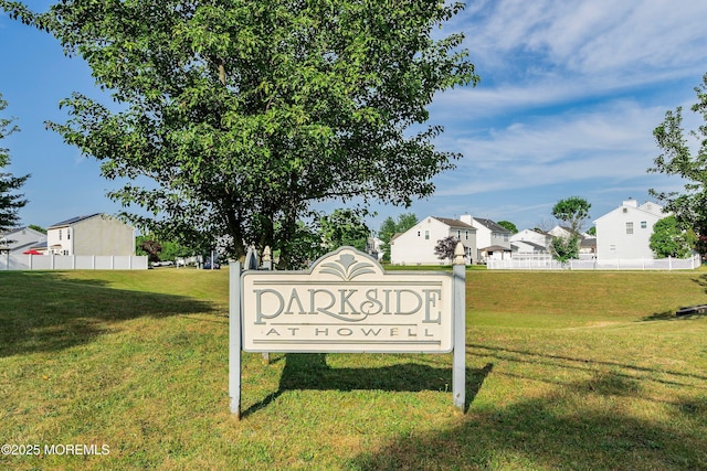 community / neighborhood sign featuring a lawn