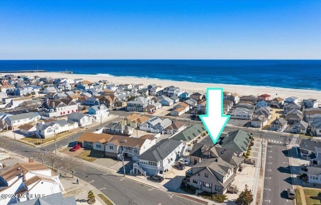 bird's eye view featuring a view of the beach and a water view