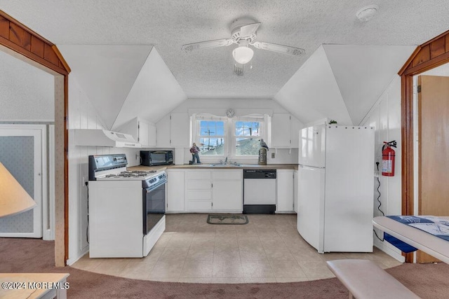 kitchen featuring ceiling fan, vaulted ceiling, a textured ceiling, white appliances, and white cabinets