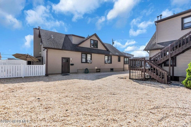 rear view of property featuring cooling unit