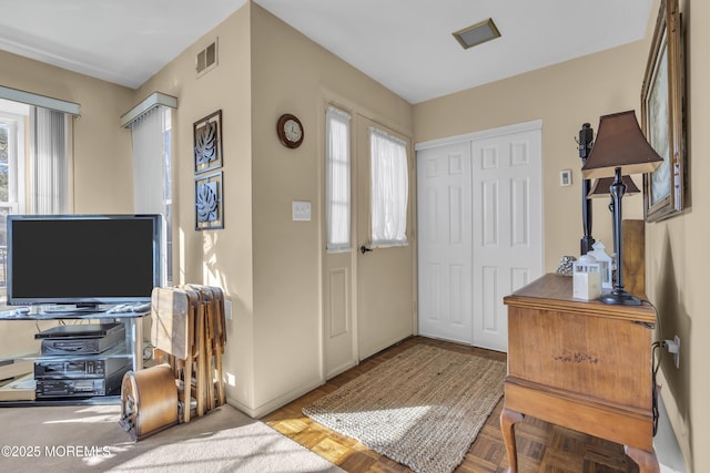 foyer entrance featuring parquet flooring