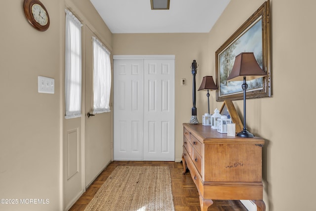 foyer entrance with dark parquet floors