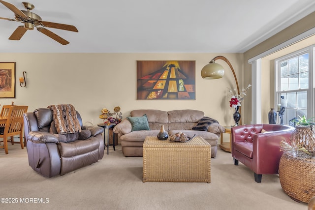 carpeted living room with ceiling fan