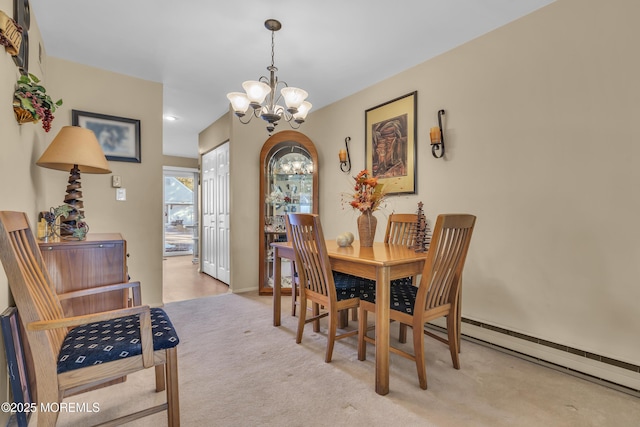 dining space featuring light carpet and an inviting chandelier