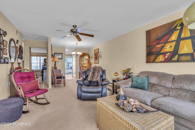 living room with ceiling fan with notable chandelier and carpet