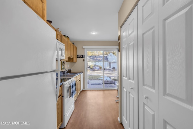 kitchen featuring white appliances and light hardwood / wood-style floors