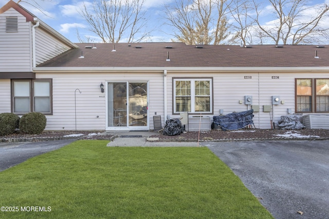 rear view of house with a lawn